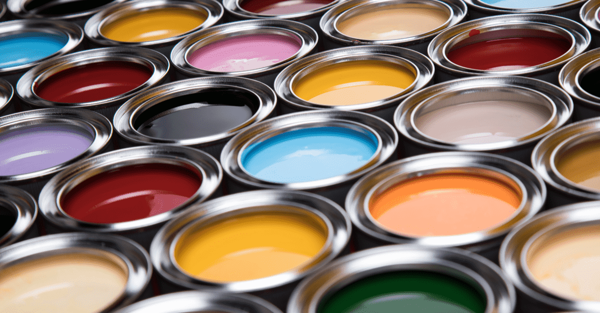 several open paint conainers side by side with open lids showing various colors 