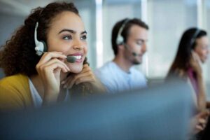 Woman on a headset answering a phone call with a smile 